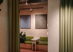 hotel lobby with art work above green banquette