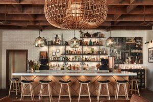 wood bar and wicker light in open air bar at the bungalow