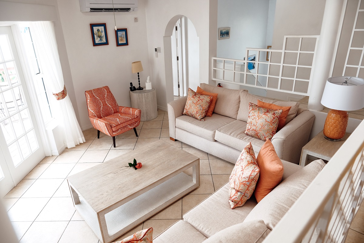 lounge in hotel suite in white and cream with coral accents