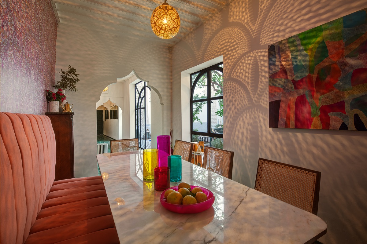 pink banquette in dining room with australian art and moroccan design