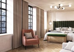 green upholstered headboard in guestroom with pink velvet chair and industrial style windows in The Store Oxford