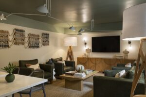 work table and seating with oversized standing lamps in Hotel Avante