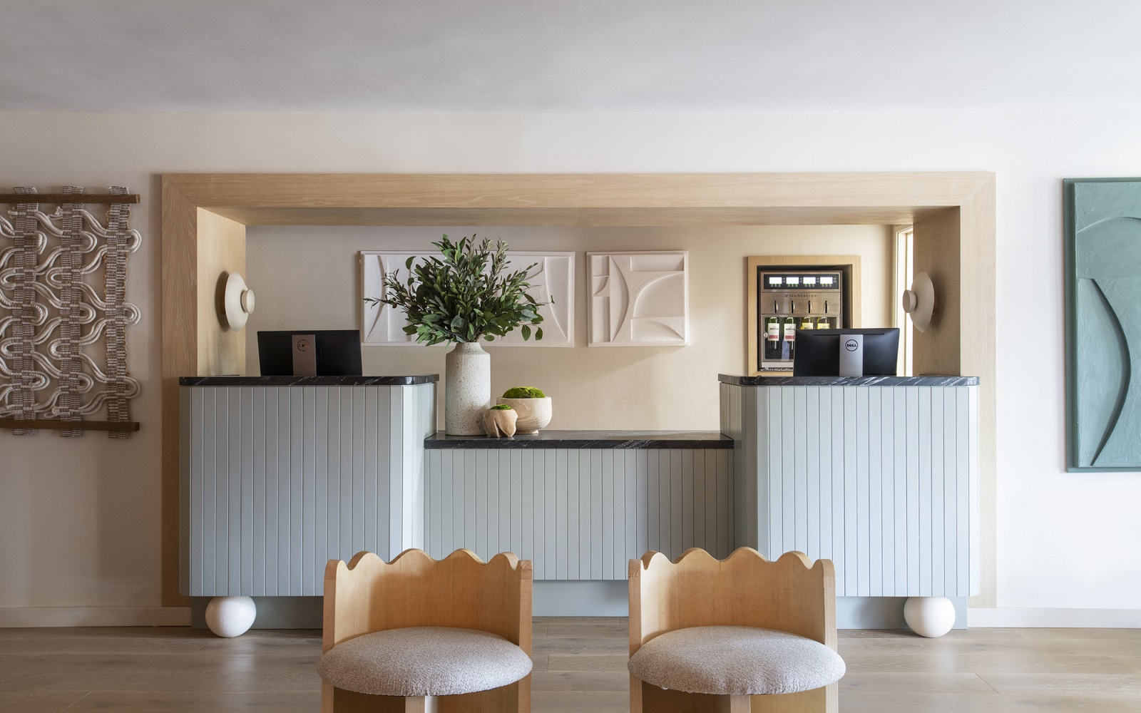 two chairs in front of reception desk at Hotel Avante by BHDM Design