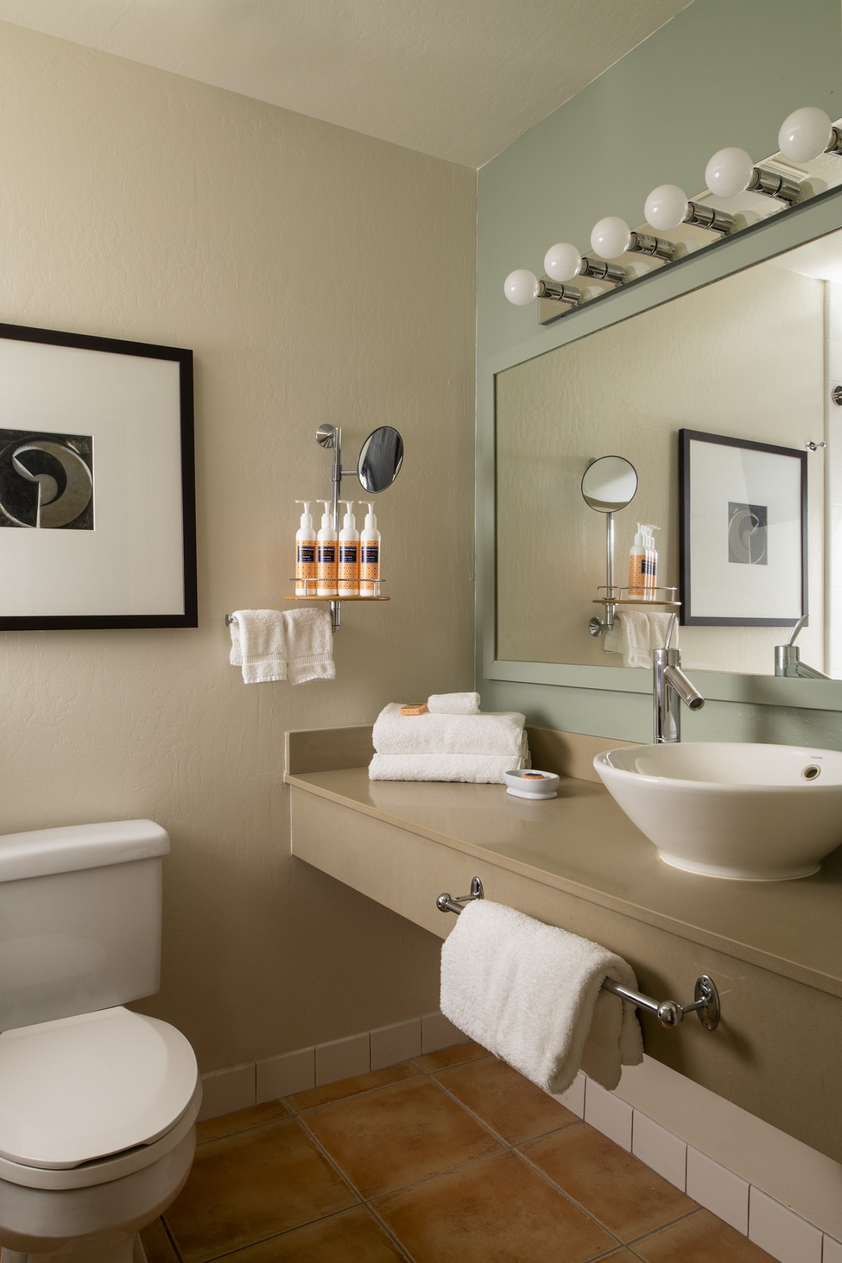 hotel bathroom design by BHDM design with surface mounted basin and hollywood lights above the mirror