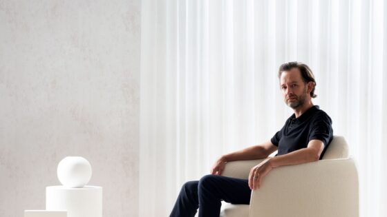 designer Tim rundle seated in white Bilbao chair in white room setting