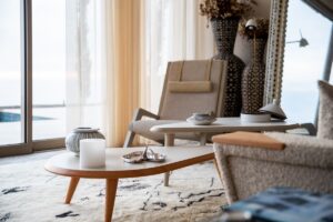 corner of a guestroom with seating and a round coffee table over a soft moroccan carpet