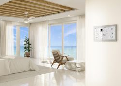 white on white hotel guestroom with wooden ceiling and floor to ceiling windows with ocean view