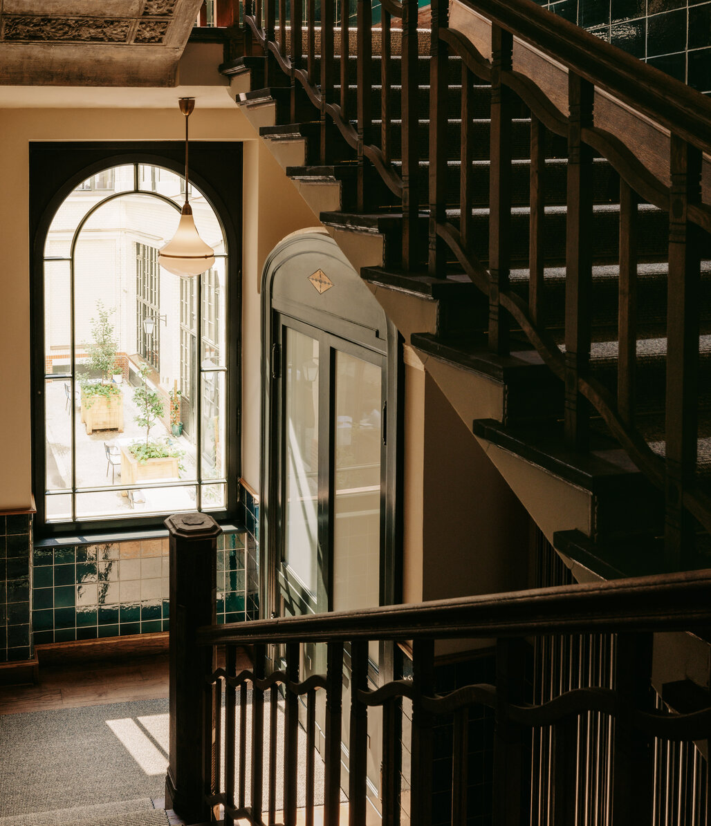 stairway with arched window overlooking hotel courtyard