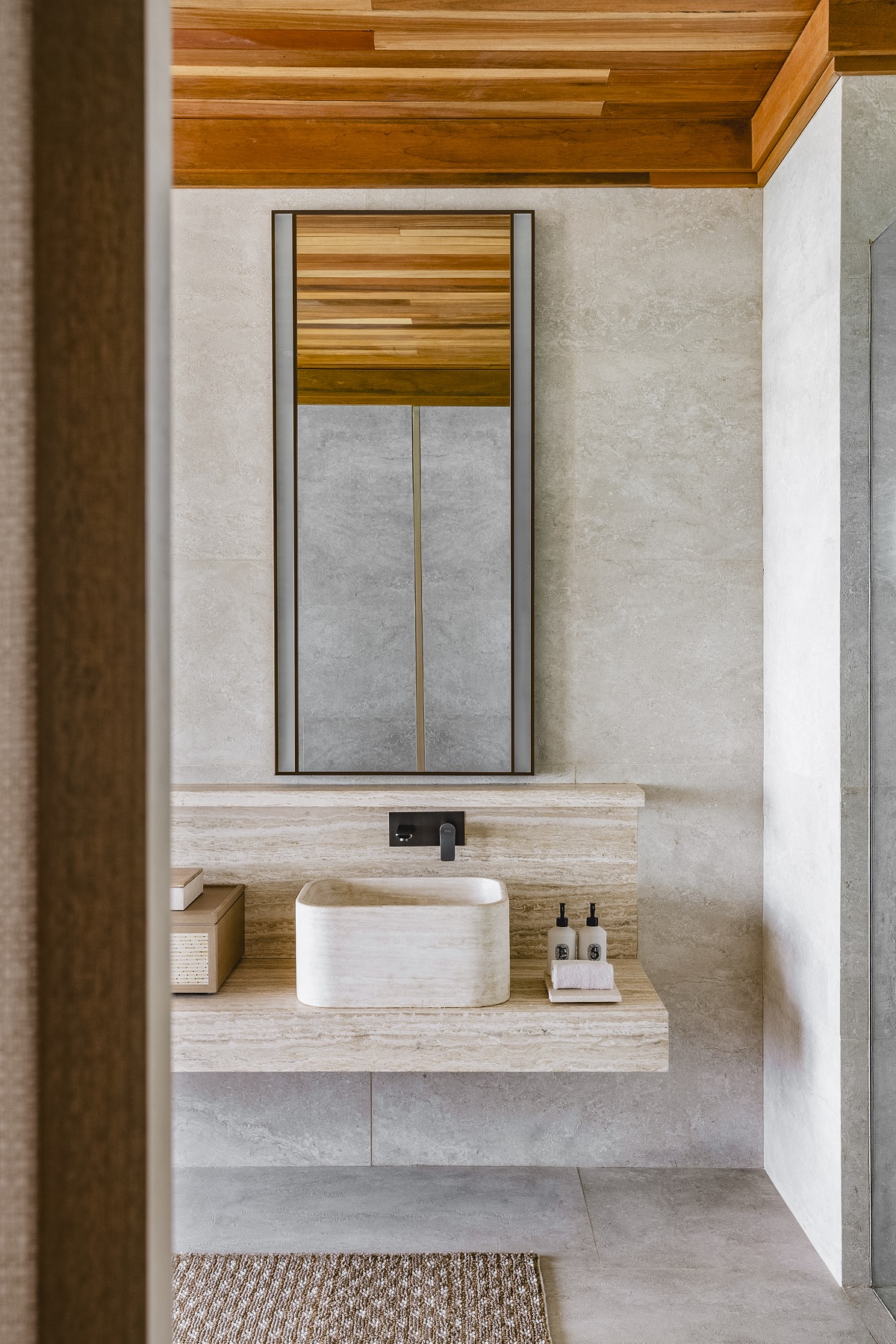 view through to bathroom with natural fibres and stone finishes