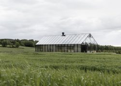 reflective exterior of restaurant in a field of grass