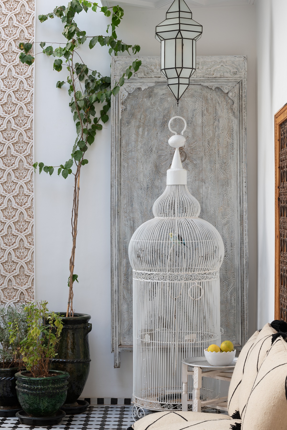 birdcage and black and white floor cushions in marrakech riad