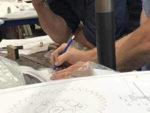 a detail image of hands and tools working on a lighting project in the Dernier & Hamlyn workshop