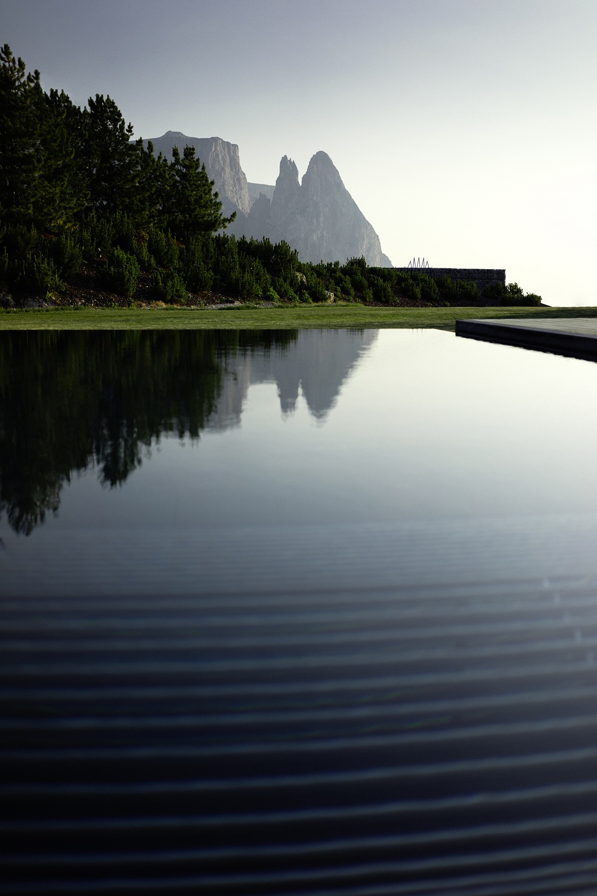 infinity pool with view of Dolomite mountains