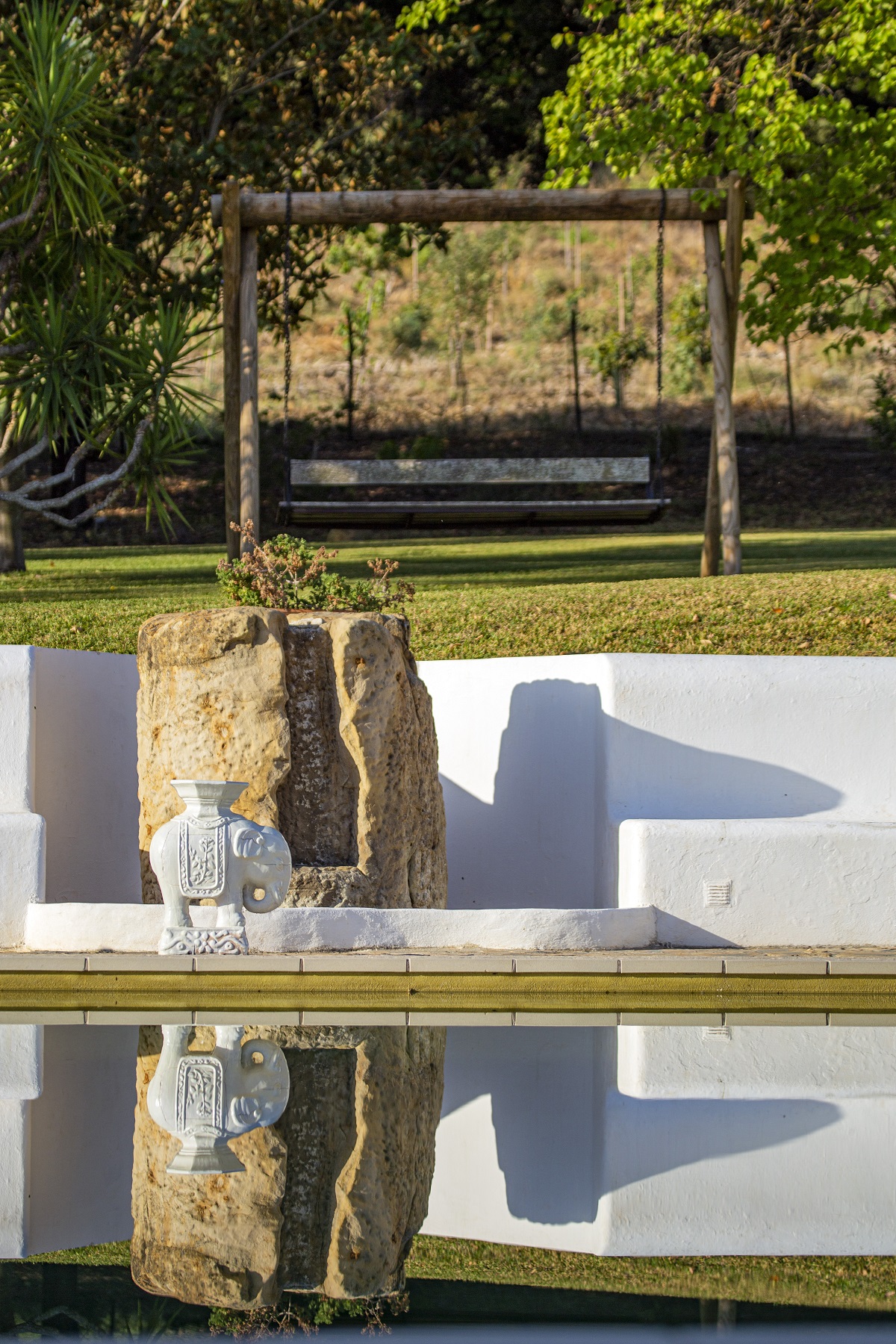 reflections and view across swimming pool at spanish boutique hotel