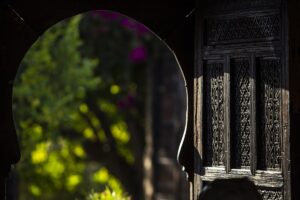 view through an old wooden door into the hotel courtyard