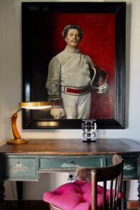 traditional portrait above a vintage desk with an art deco spanish design lamp