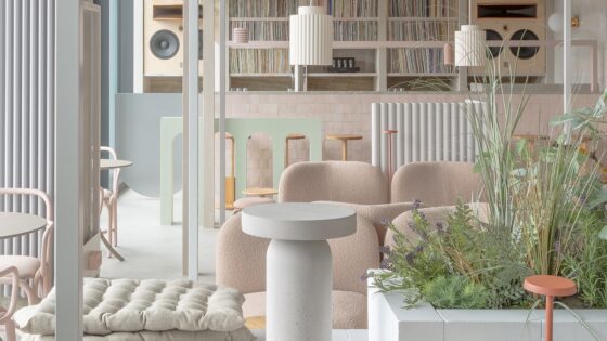 white and cream contemporary interior with blond wood and plants and soft seating on the floor