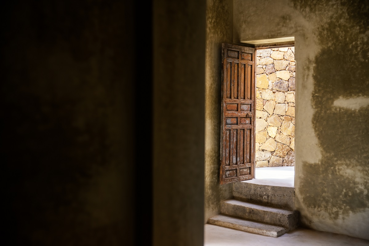 traditional moroccan carved wooden door opens into a hammam