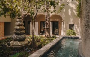 inner courtyard with water and sculptural fountain surrounded by trees