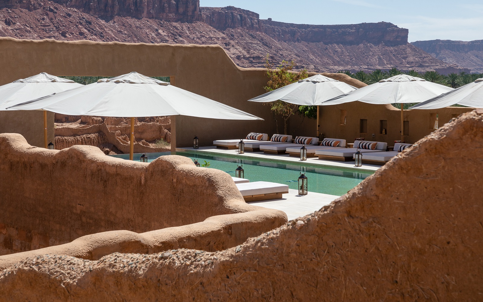 mud walls, pool and mountains in AlUla