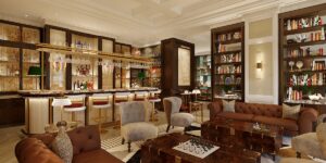 wooden shelving, mirrored bar and comfortable curved seating in the Library Bar