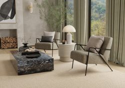 chairs and marble table in lounge with fireplace