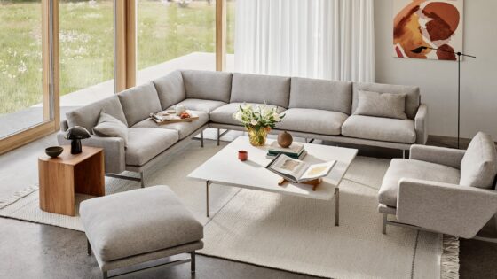 cream L shaped Lissoni couch from Fritz Hansen in front of floor to ceiling window