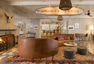 lobby in The Leta hotel with suspended surfboard above and patterned carpet below