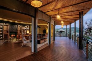 curved wooden facade of tented structure with wooden frame at Madwaleni River Lodge