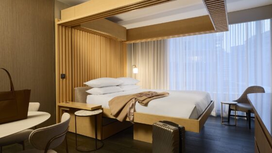 A wooden frame bed in hotel room