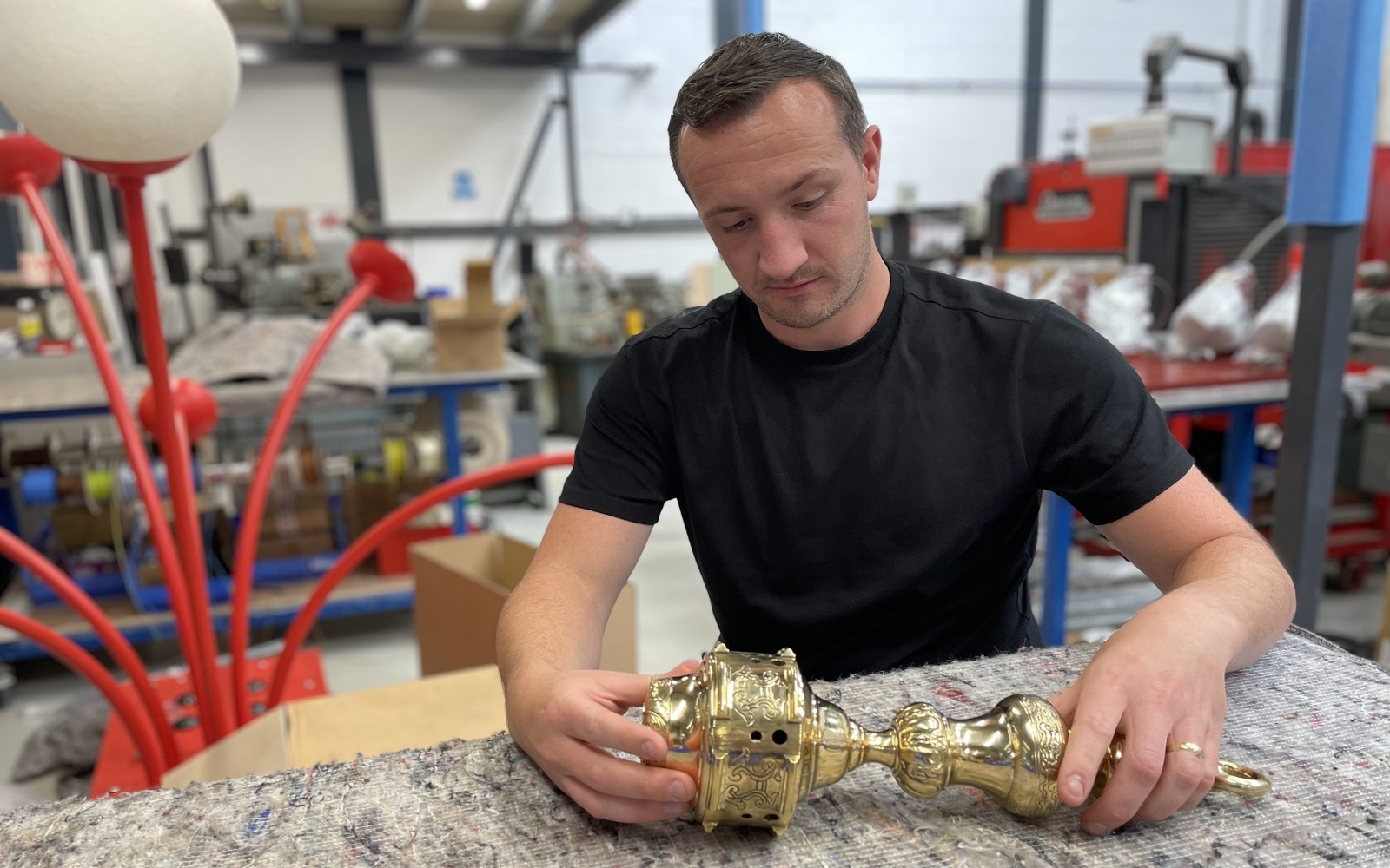 Michael Mulhall from Dernier & Hamlyn working on a light fitting in the workshop