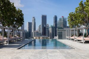 rooftop infinity pool leading onto view of Singapore city skyline from Mondrian Singapore Duxton