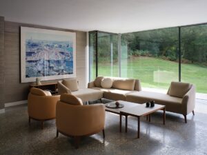 chairs and couch from Morgan collection designed by tim rundle in front of floor to ceiling glass wall in lounge