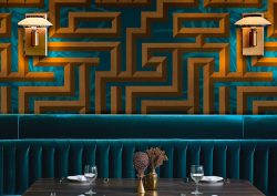 blue velvet banquette with blue and gold optic tropicwallpaper