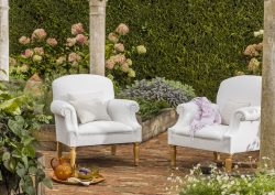 upholstered George Smith chairs in the garden with tea tray