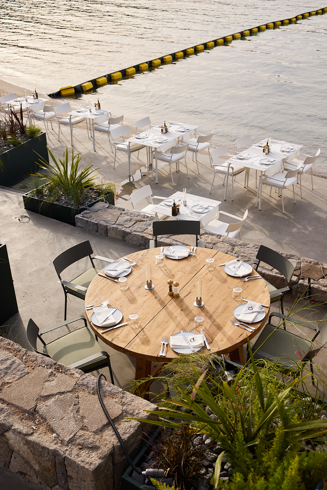 wooden table at outdoor restaurant next to the sea