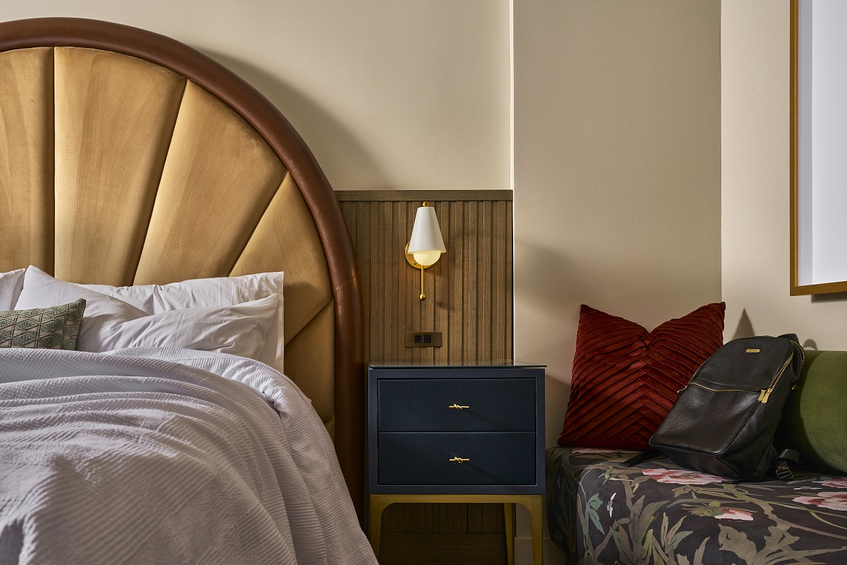 fan headboard and table detail in hotel guestroom