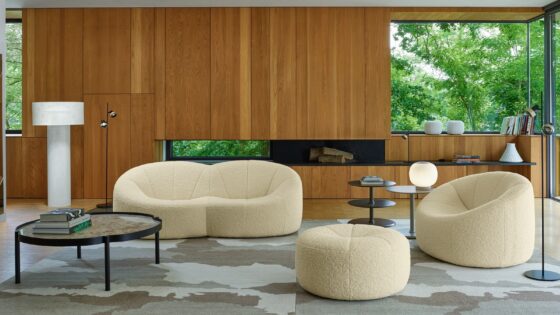 lounge with wooden panelled walls and mid century design furniture in cream from Ligne Roset