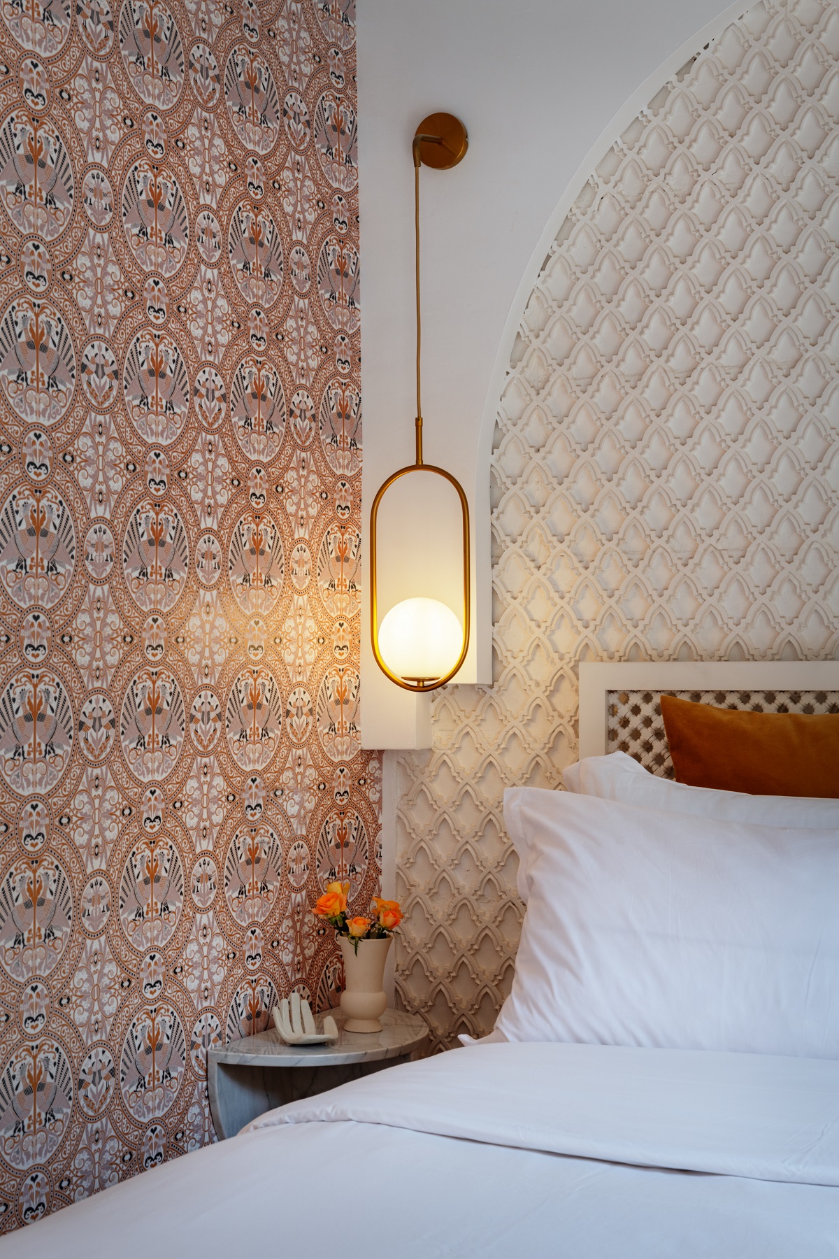 bed, lighting and wallpaper detail in the riad