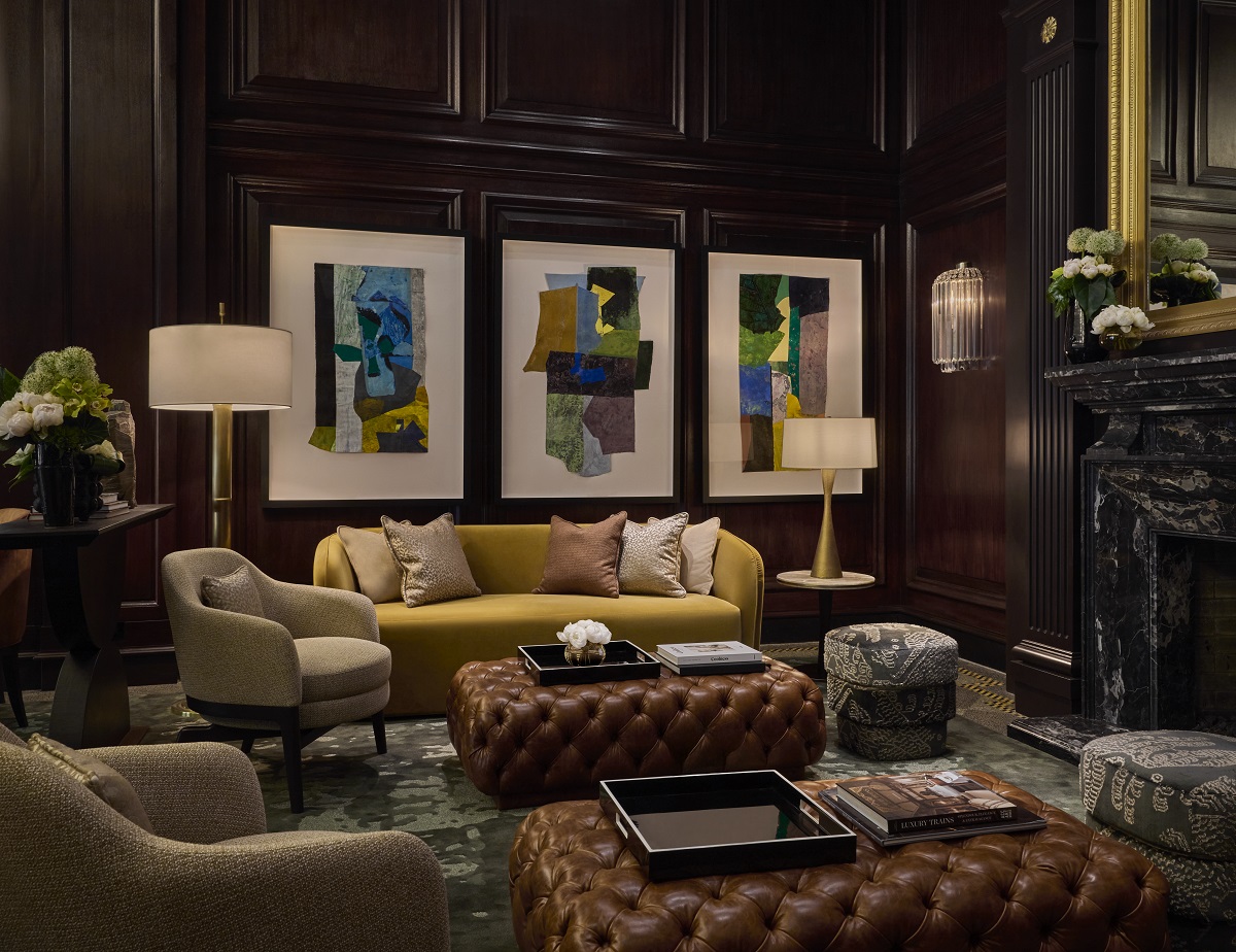 wooden panelling , leather couches and art on the walls in the hotel lobby