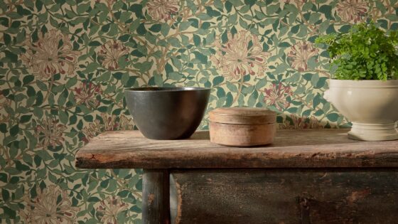 wooden shelf with bowls in front of morris & co wallpaper