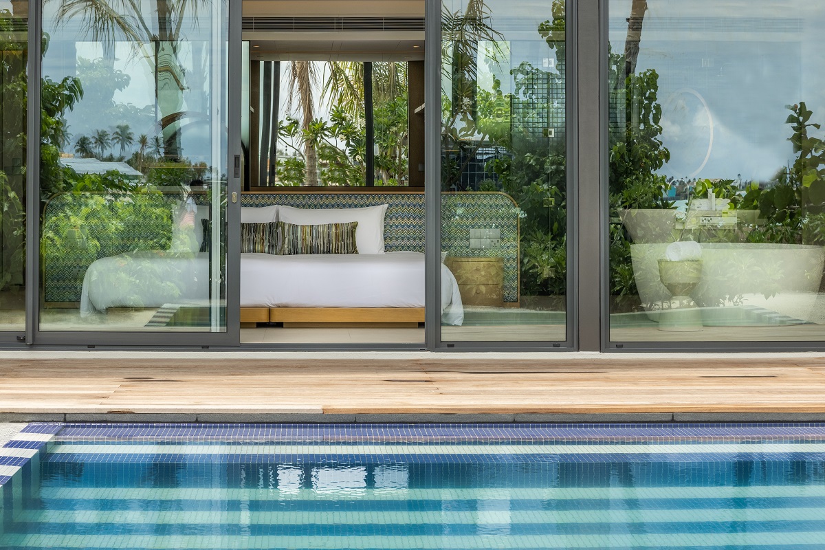 glass doors from guestroom open on to private pool and deck at SO/ Maldives