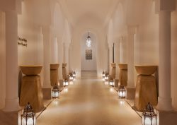 columns and candlelight leading into the spa at The St Regis Tamuda Bay