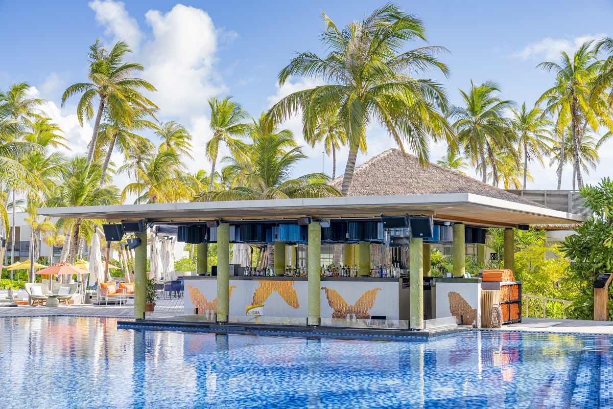 pool bar and pool surrounded by palm trees at The Elephant & The Butterfly Pool Bar