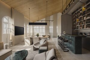 Cream and natural interion with dark accents and view from seating area across to mini bar and dining room table in the Shophouse Suite