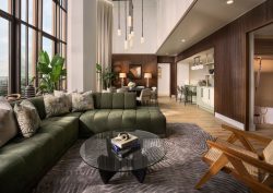 couch glass table and wooden chair in tower suite at boca raton