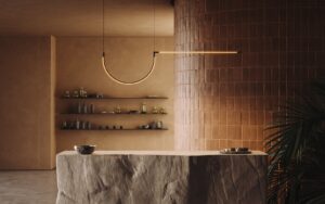 stone counter in front of brown tiled wall with architectural tubular lighting above from LedsC4