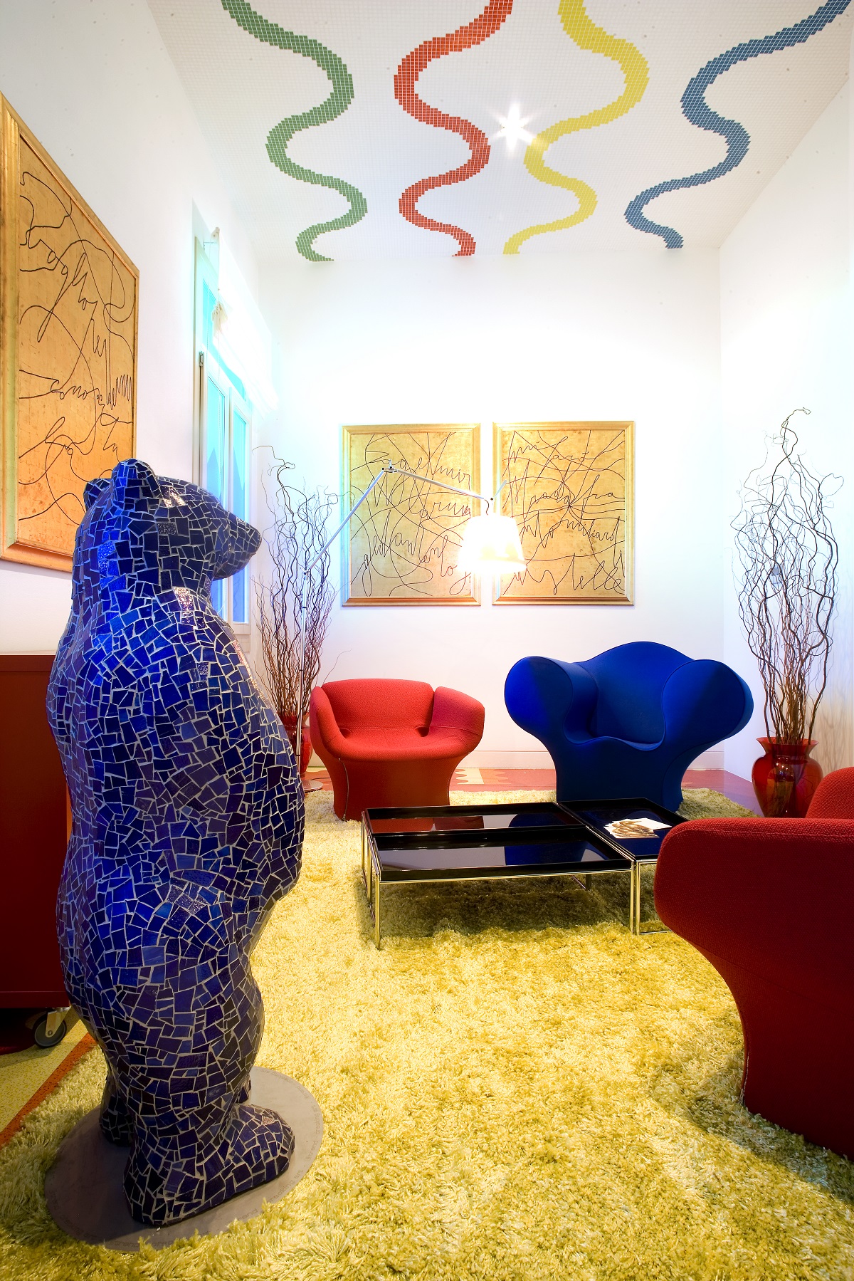 room with patterned ceiling and mosaic bear sculpture