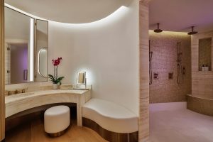 curved vanity with concealed lighting with mosaic surface in the showers in Espa waldorf Doha