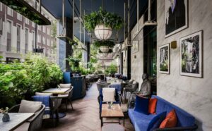 blue velvet seating and plants in cocktail bar at Hyatt Regency London